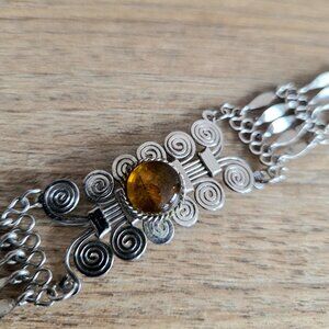 Silver color metal bracelet with faux Amber glass stone.